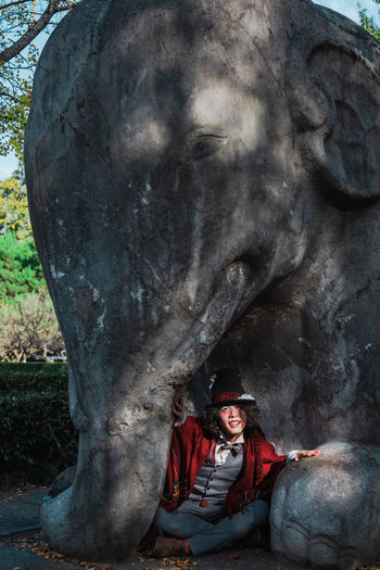 Portrait of man with statue