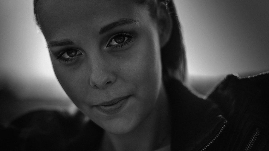 Close-up portrait of a smiling young woman at home