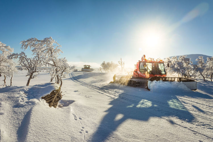 Construction vehicle cleaning snow during winter