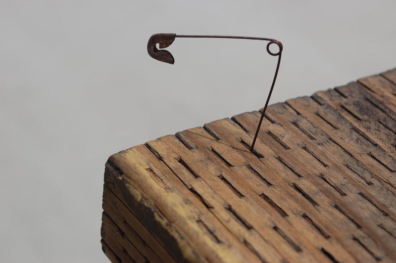 Close-up of safety pin on wooden table