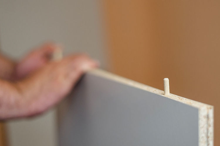 Close-up of man hand on wall