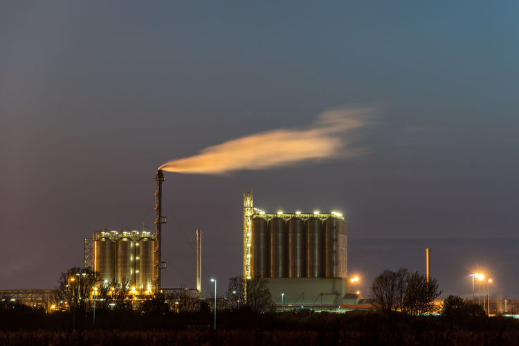 Smoke emitting from factory against sky at night