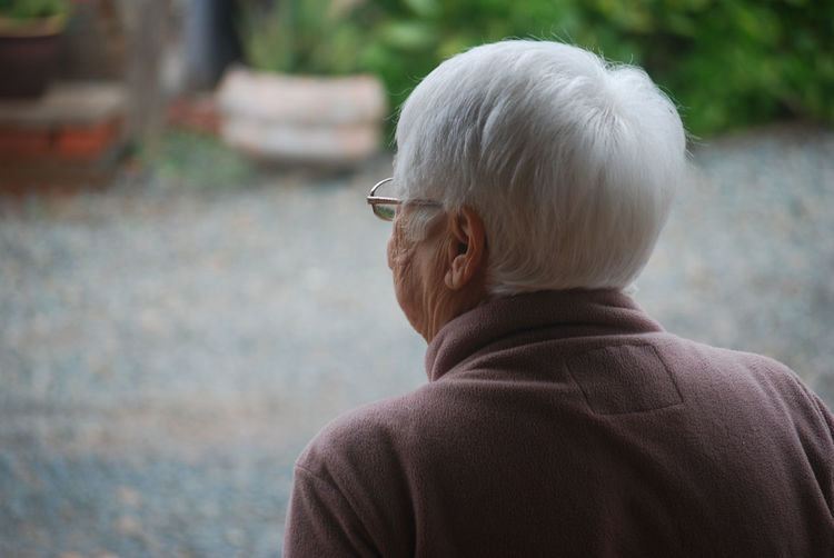Rear view of old woman looking away