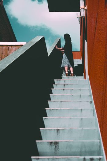 Rear view of woman walking on stairs