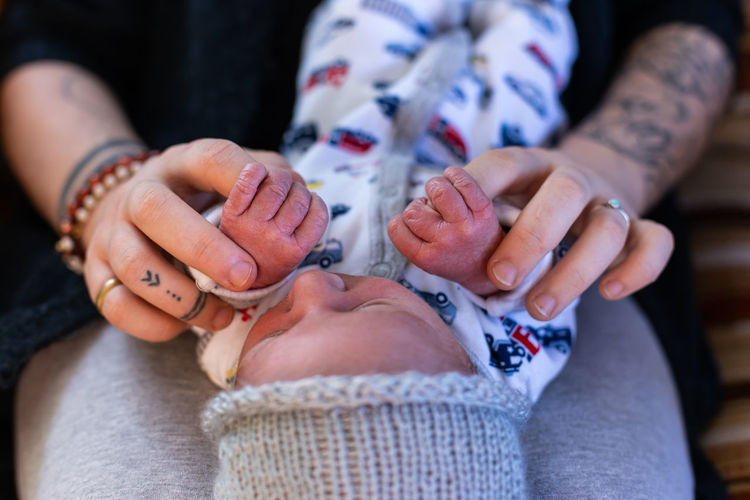 Midsection of mother playing with baby