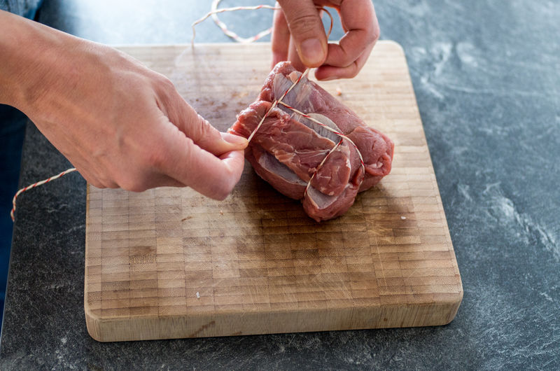 High angle view of man preparing food on cutting board