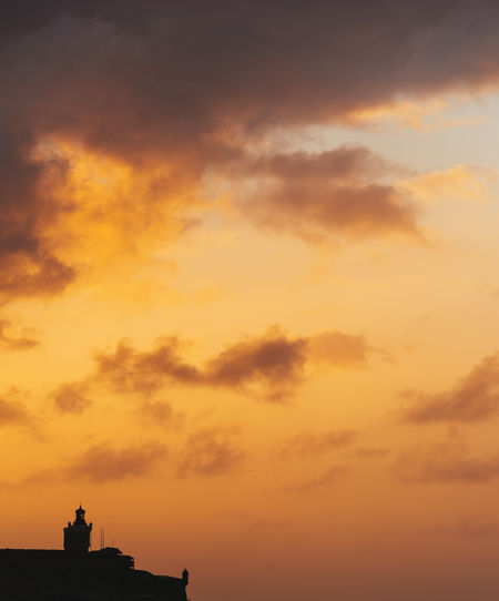 Low angle view of silhouette building against sky during sunset