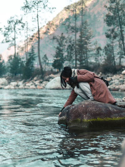 Woman on river in forest