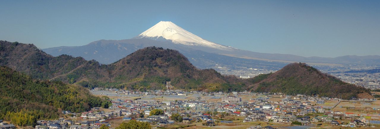 Scenic view of snowcapped fuji san against clear sky