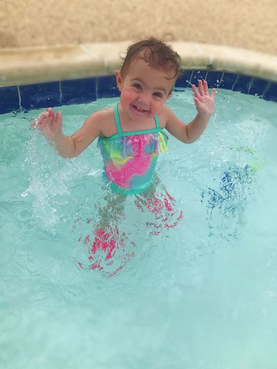 Happy girl enjoying in swimming pool