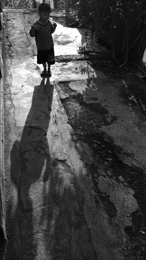 Full length rear view of man walking on street