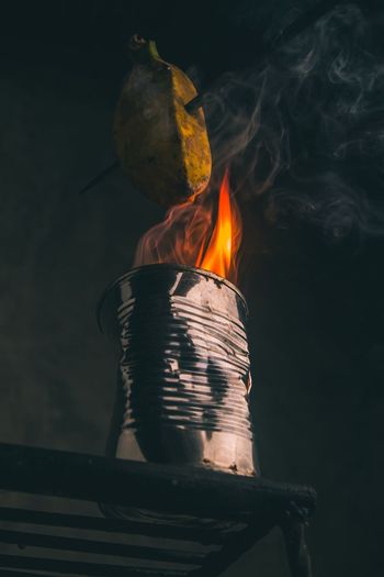 Close-up of fire burning with banana at night