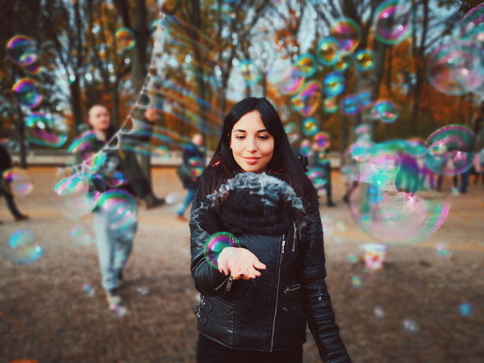 High angle view of woman and bubbles in park
