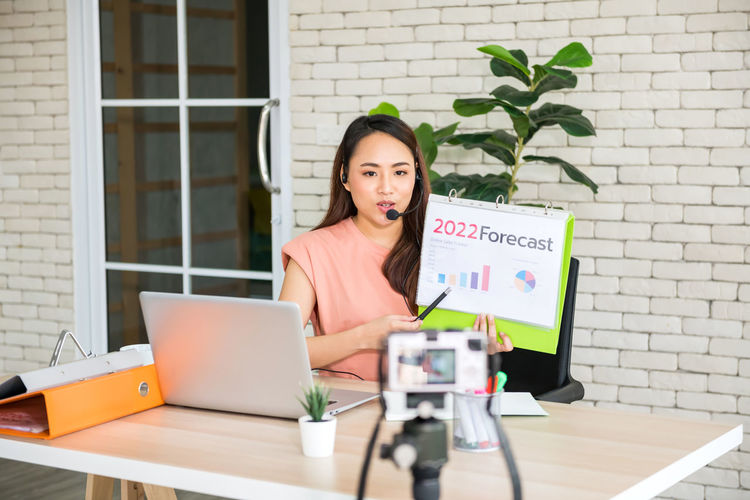 Recording young business influencer show sale 2022 forecast to audience by camera. 