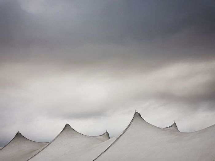 A stormy sky looms over the tent tops of a septemberfest street fair.