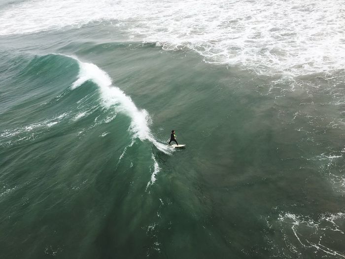 High angle view of boy surfing on sea