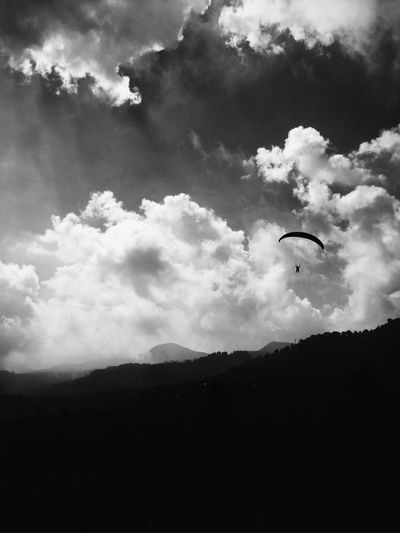 Scenic view of mountains against cloudy sky