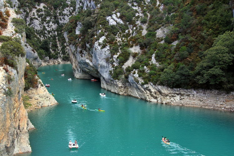 High angle view of people on rock by sea