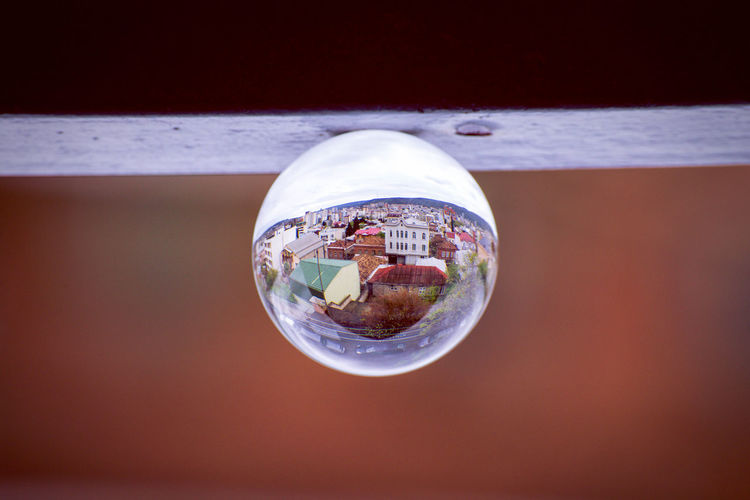 Close-up of reflection of crystal ball on glass