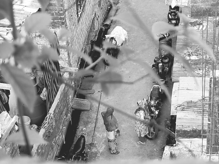 High angle view of people standing on street amidst field