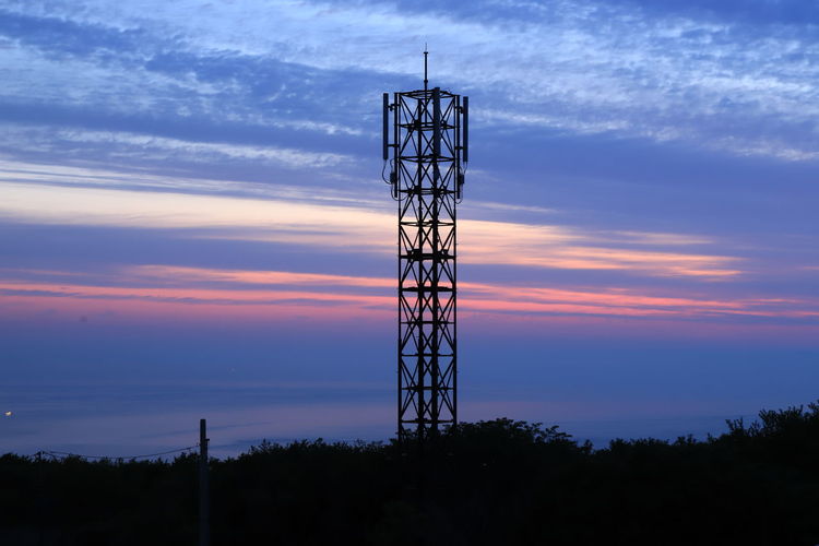 Low angle view of silhouette tower against sky during sunset
