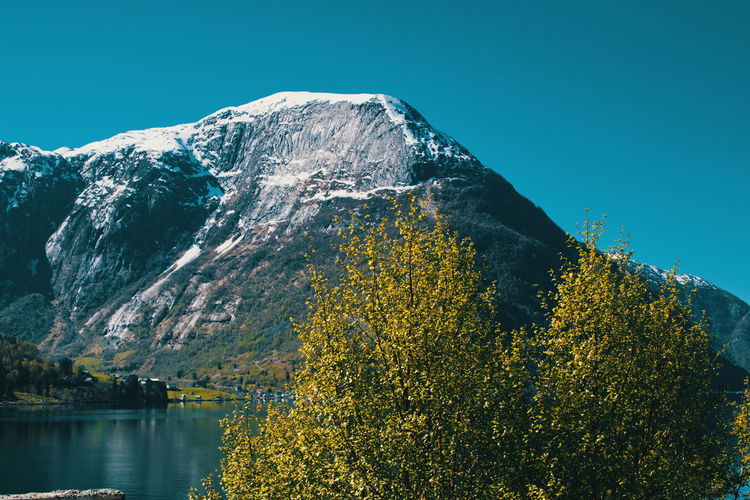 Scenic view of snowcapped mountains against clear sky