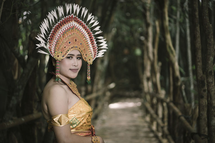 Portrait of woman wearing traditional clothing standing outdoors