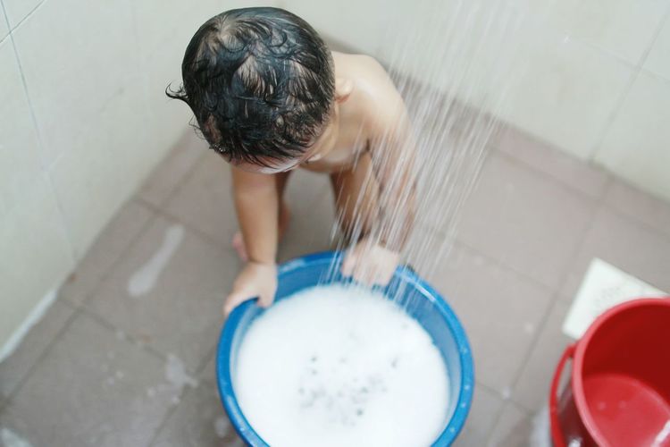 High angle view of boy at shower
