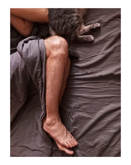 Midsection of man resting on bed
