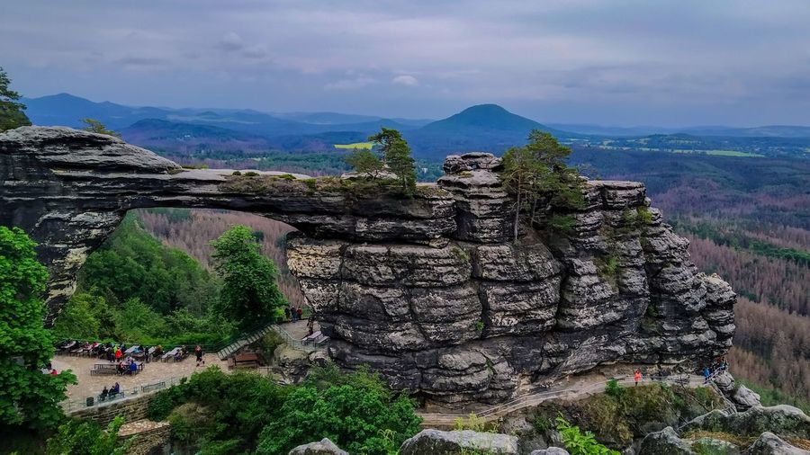 Scenic view of mountain range against cloudy sky
