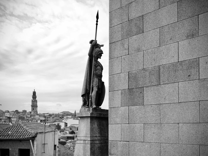 Statue of building against cloudy sky