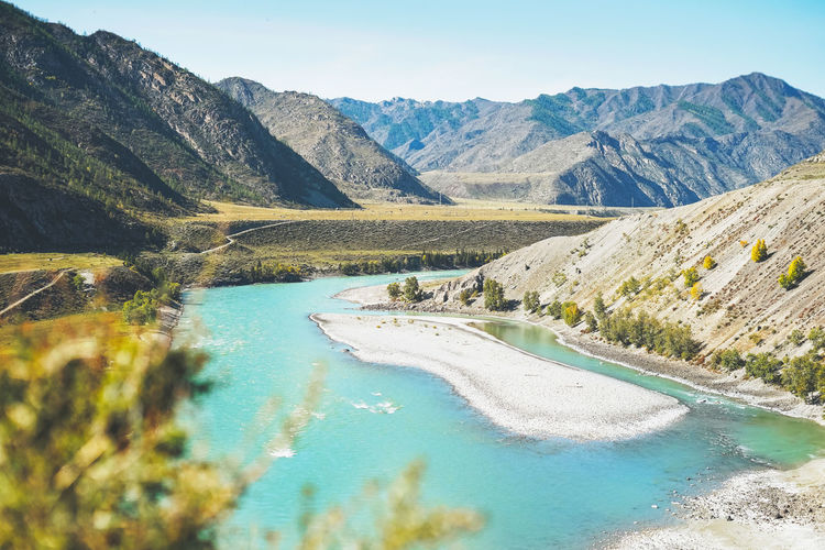 View of the turquoise river katun and the altai mountains, autumn season