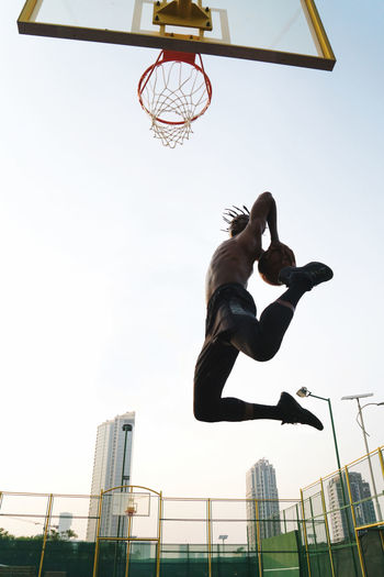 Black man playing basketball game