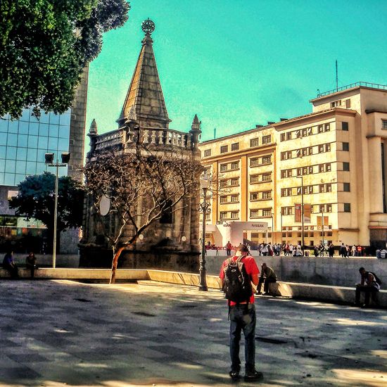 People walking on street against buildings in city
