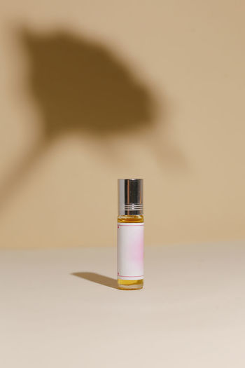 Close-up of perfume on table