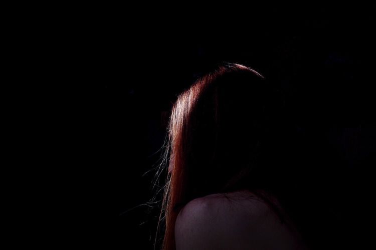 Headshot of woman in darkroom