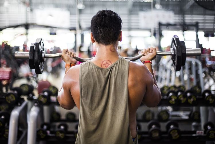 Rear view of man exercising at gym
