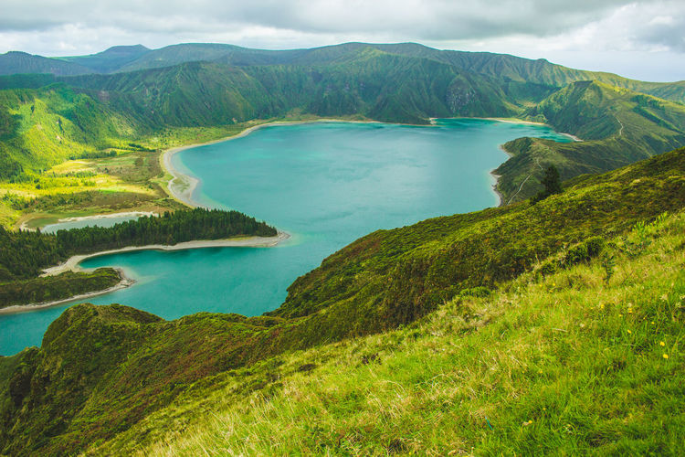 Scenic view of lake and mountains against sky