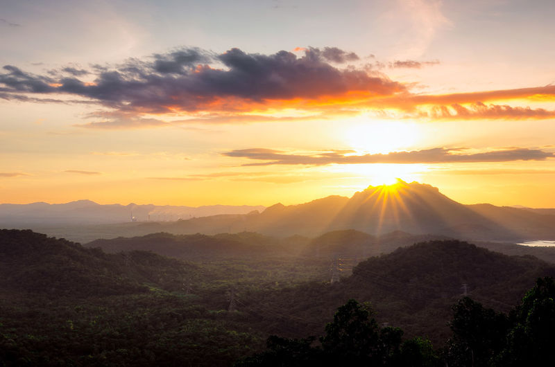 Beautiful landscape sunset over peak mountain with warm light mae moh lampang, thailand.