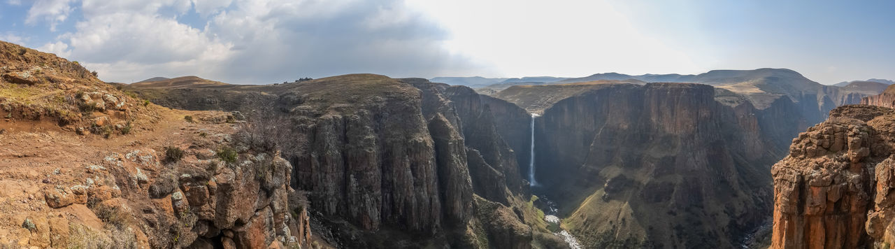 Panoramic view of landscape with canyon and maletsunyane waterfall against dramatic sky, semonkong, lesotho, africa