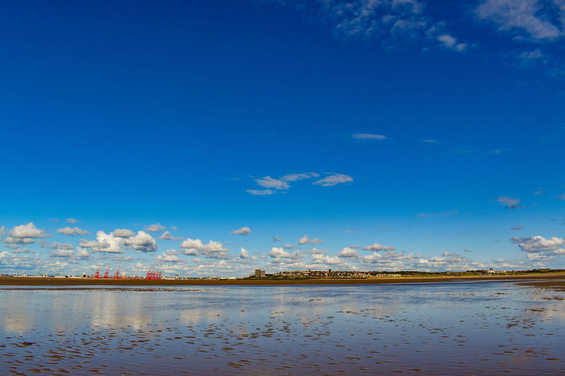 Scenic view of lake against blue sky