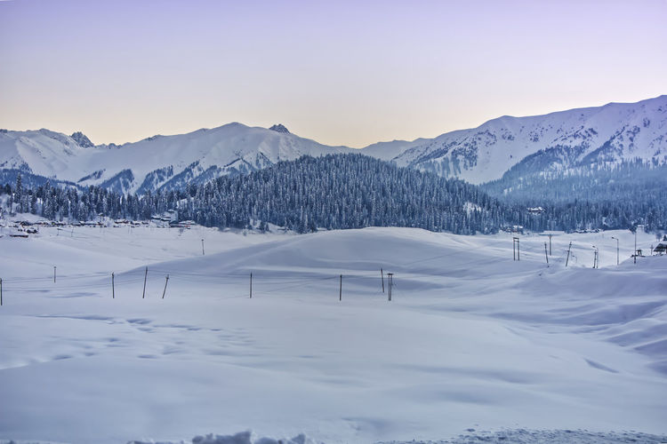 Scenic view of snow covered mountains against sky, gulmarg kashmir 2021