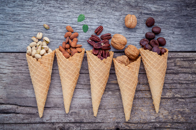 Directly above shot of ice cream cones filled with nuts