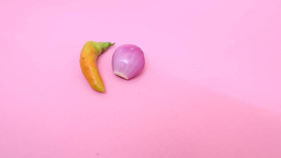 High angle view of fruit on pink background
