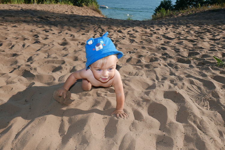 High angle view of boy on sand at beach