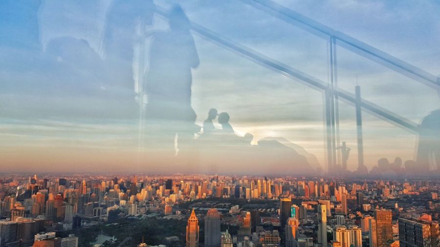 Digital composite image of cityscape against sky