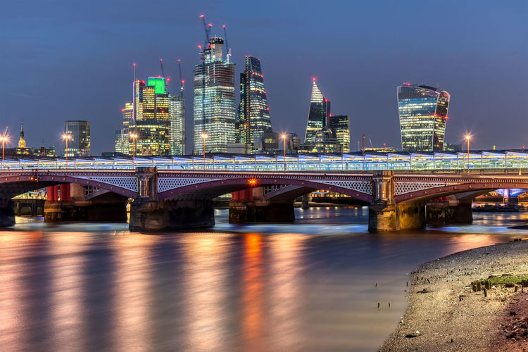Blackfriars bridge and the skyscrapers of the city of london at night