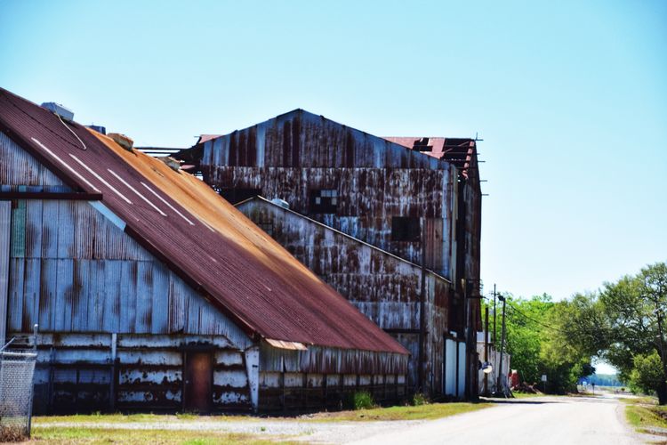 Exterior of old building against clear blue sky