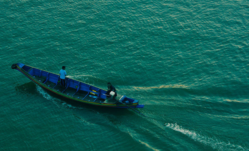 High angle view of people on boat in sea