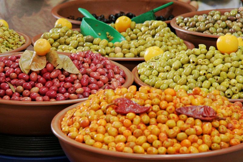 High angle view of colorful olives in container for sale
